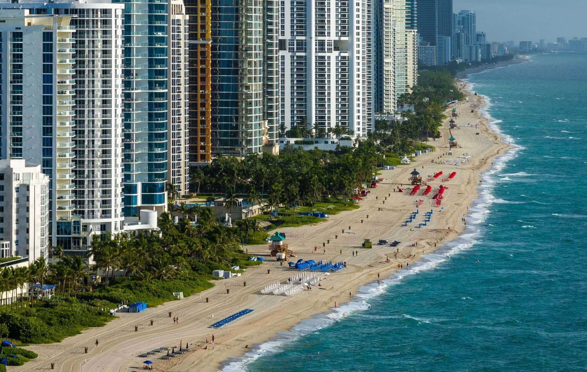 Oceanfront towers above the beach in Sunny Isles Beach on a morning with surf