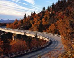 Linn Cove Viaduct on the Blue Ridge Parkway curving through autumn foliage on Grandfather Mountain