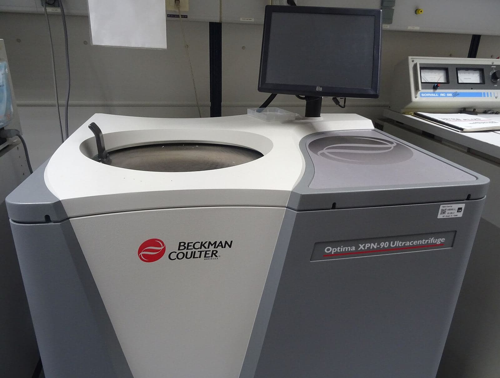 A white floor-standing laboratory ultracentrifuge with its lid open and a touchscreen panel
