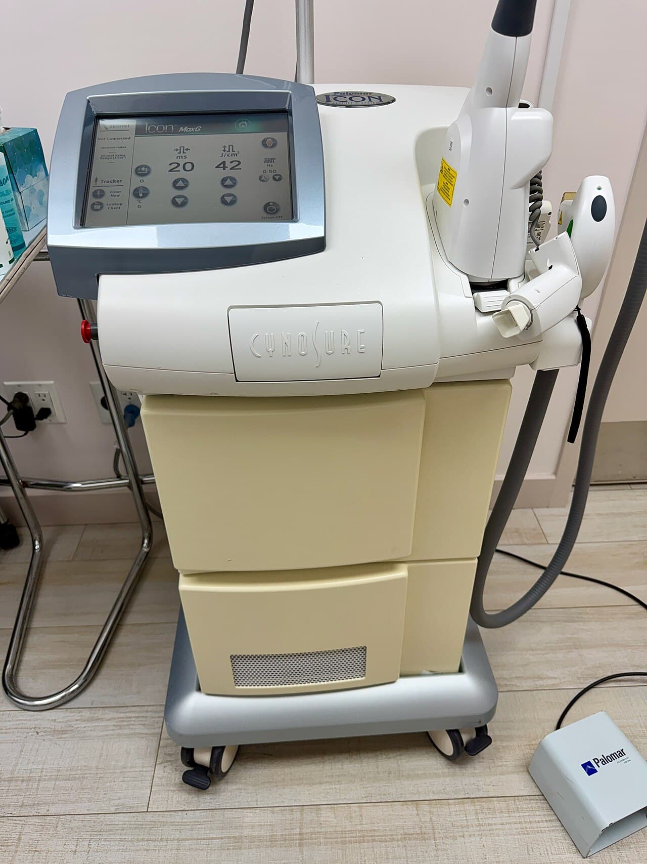 Cynosure Icon aesthetic platform with its console and handpiece on a cart