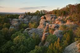 Sandstone rock formations above the forest at Garden of the Gods in Shawnee National Forest at sunset
